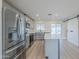Modern kitchen featuring stainless steel appliances, white countertops, an island, and a sliding barn door at 3220 E Andorra Dr, Phoenix, AZ 85032