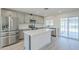 Modern kitchen featuring stainless steel appliances, white countertops, an island, and access to the patio at 3220 E Andorra Dr, Phoenix, AZ 85032
