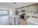 Modern kitchen featuring stainless steel appliances, white countertops, an island, and bright wood flooring at 3220 E Andorra Dr, Phoenix, AZ 85032