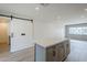 Modern kitchen featuring white countertops, an island with drawers, and a sliding barn door nearby at 3220 E Andorra Dr, Phoenix, AZ 85032