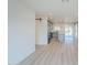 Open-concept living room with wood flooring leading to kitchen area with modern appliances and island at 3220 E Andorra Dr, Phoenix, AZ 85032