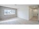Open-concept living room with brick accent wall and large window, leading to kitchen area at 3220 E Andorra Dr, Phoenix, AZ 85032