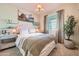 Stylish bedroom with neutral colors, a comfortable bed, and a potted tree by the window at 3347 E Outlaw Ln, San Tan Valley, AZ 85140