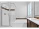 Bright bathroom features a glass shower, soaking tub, and vanity with framed mirror at 3504 E Pinto Dr, Gilbert, AZ 85296