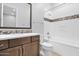 Bathroom with modern vanity, toilet, and tub shower with decorative backsplash at 3504 E Pinto Dr, Gilbert, AZ 85296