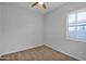 Bedroom with a ceiling fan and carpeted floors and white window shutters at 3504 E Pinto Dr, Gilbert, AZ 85296