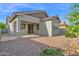 Back exterior of the home with a covered patio and desert landscaping at 3504 E Pinto Dr, Gilbert, AZ 85296
