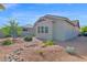 Charming home featuring desert landscaping, with gravel, boulders, and drought-tolerant plants under a bright blue sky at 3504 E Pinto Dr, Gilbert, AZ 85296