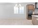 Bright kitchen area featuring modern appliances, wood cabinets, tile floors and a chandelier at 3504 E Pinto Dr, Gilbert, AZ 85296