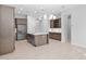 Spacious open kitchen with stainless steel appliances, large island, and modern lighting fixtures at 3504 E Pinto Dr, Gilbert, AZ 85296