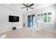 Bright living room featuring tile floors, modern ceiling fan, and a sliding glass door with backyard access at 3504 E Pinto Dr, Gilbert, AZ 85296