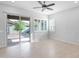 Bright living room featuring tile floors, ceiling fan, and a sliding glass door with backyard access at 3504 E Pinto Dr, Gilbert, AZ 85296