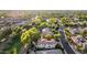 Expansive aerial view of a beautiful suburban neighborhood with lush greenery, manicured lawns, and a lake with a fountain at 3683 E Nolan Dr, Chandler, AZ 85249