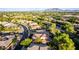 A picturesque suburban neighborhood with beautiful homes, green spaces, and a lake featuring a fountain with mountain views at 3683 E Nolan Dr, Chandler, AZ 85249