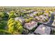 An aerial view of a neighborhood showcasing lush landscaping, variety of home styles, and well maintained street at 3683 E Nolan Dr, Chandler, AZ 85249