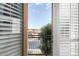 A cozy balcony offers scenic neighborhood views through shuttered doors, blending indoor comfort with outdoor serenity at 3683 E Nolan Dr, Chandler, AZ 85249