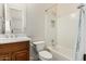 Well-lit bathroom with a shower-tub combo and a wooden vanity with a white countertop and chrome fixtures at 3683 E Nolan Dr, Chandler, AZ 85249