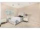 Bright bedroom featuring neutral colors, carpet floors, plantation shutters, and a ceiling fan at 3683 E Nolan Dr, Chandler, AZ 85249