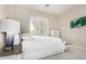 A bright, neutral bedroom features shuttered windows and white furniture, offering a serene retreat at 3683 E Nolan Dr, Chandler, AZ 85249