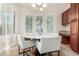 Inviting breakfast nook with plantation shutters, a chandelier, and seating for four in a brightly lit setting at 3683 E Nolan Dr, Chandler, AZ 85249