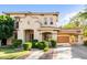Stunning two-story home featuring stucco siding, a tile roof, manicured landscaping, and a porte-cochère at 3683 E Nolan Dr, Chandler, AZ 85249