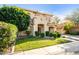 Charming two-story house showcasing lush green grass, mature landscaping, and a porte-cochère at 3683 E Nolan Dr, Chandler, AZ 85249