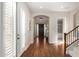 Inviting foyer featuring hardwood floors, a decorative chandelier, and staircase at 3683 E Nolan Dr, Chandler, AZ 85249