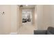 Hallway with neutral colors offers glimpses into a naturally lit sitting room at 3683 E Nolan Dr, Chandler, AZ 85249