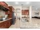 Modern kitchen boasts stainless steel appliances, granite countertops, ample cabinet space, and center island with sink at 3683 E Nolan Dr, Chandler, AZ 85249