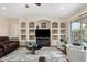 Bright living room with built-in shelving, contemporary furnishings, and access to the outdoors at 3683 E Nolan Dr, Chandler, AZ 85249