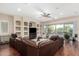 Spacious living room with built-in shelving, a ceiling fan, and a large sectional sofa at 3683 E Nolan Dr, Chandler, AZ 85249