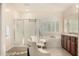 Bright bathroom featuring dual vanities, a separate shower, and a soaking tub with plantation shutters at 3683 E Nolan Dr, Chandler, AZ 85249