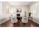 Bright office space featuring hardwood floors, a large wooden desk, and natural light from two large windows at 3683 E Nolan Dr, Chandler, AZ 85249