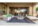 Inviting outdoor patio area with comfortable seating, stylish rug, and sliding glass doors at 3683 E Nolan Dr, Chandler, AZ 85249