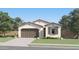 Charming single-story home with a two-car garage, desert landscaping, and a neutral color palette at 38203 N Stillmeadow Rd, San Tan Valley, AZ 85140