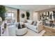 Bright living room featuring stylish furniture, modern decor, and access to an outdoor patio area at 38203 N Stillmeadow Rd, San Tan Valley, AZ 85140