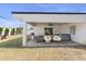 Spacious backyard with a covered patio featuring hanging chairs, comfortable seating, and outdoor entertainment space at 4025 N 8Th Ave, Phoenix, AZ 85013