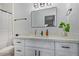 Bright bathroom featuring a vanity with modern fixtures, white countertop, and a shower with a white curtain at 4025 N 8Th Ave, Phoenix, AZ 85013