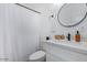 Bright bathroom featuring a vanity with modern fixtures, white countertop, and a shower with a white curtain at 4025 N 8Th Ave, Phoenix, AZ 85013