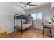 Comfortable bedroom featuring a bunk bed, wood-look flooring, and a ceiling fan at 4025 N 8Th Ave, Phoenix, AZ 85013