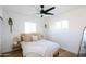Inviting bedroom featuring a bed with neutral bedding, wood-look flooring, and plenty of natural light at 4025 N 8Th Ave, Phoenix, AZ 85013