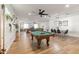 Spacious game room with a pool table, hardwood floors, a dining table, and a ceiling fan at 4025 N 8Th Ave, Phoenix, AZ 85013