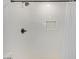 Close-up of a shower showcasing white tiled walls, a recessed shelf, and a modern black showerhead at 4025 N 8Th Ave, Phoenix, AZ 85013