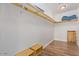 Spacious walk-in closet with built-in shelving, wood-look tile flooring, and ample storage space at 4025 N 8Th Ave, Phoenix, AZ 85013