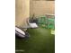 Charming backyard with artificial grass, modern seating, and colorful bar stools at 4242 N 27Th St # 2, Phoenix, AZ 85016
