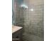 Modern glass enclosed shower with gray tiles, next to vanity with undermount sink at 4242 N 27Th St # 2, Phoenix, AZ 85016