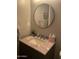 Bathroom vanity features a round mirror, granite countertop, and stylish faucet at 4242 N 27Th St # 2, Phoenix, AZ 85016