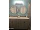 Bright bathroom featuring a double vanity with modern fixtures and stylish round mirrors at 4242 N 27Th St # 2, Phoenix, AZ 85016