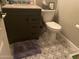 Compact bathroom features a modern vanity, toilet, and unique patterned flooring at 4242 N 27Th St # 2, Phoenix, AZ 85016