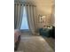 Comfortable bedroom with a plush chair, large window with curtains, and a decorative cow-themed picture at 4242 N 27Th St # 2, Phoenix, AZ 85016